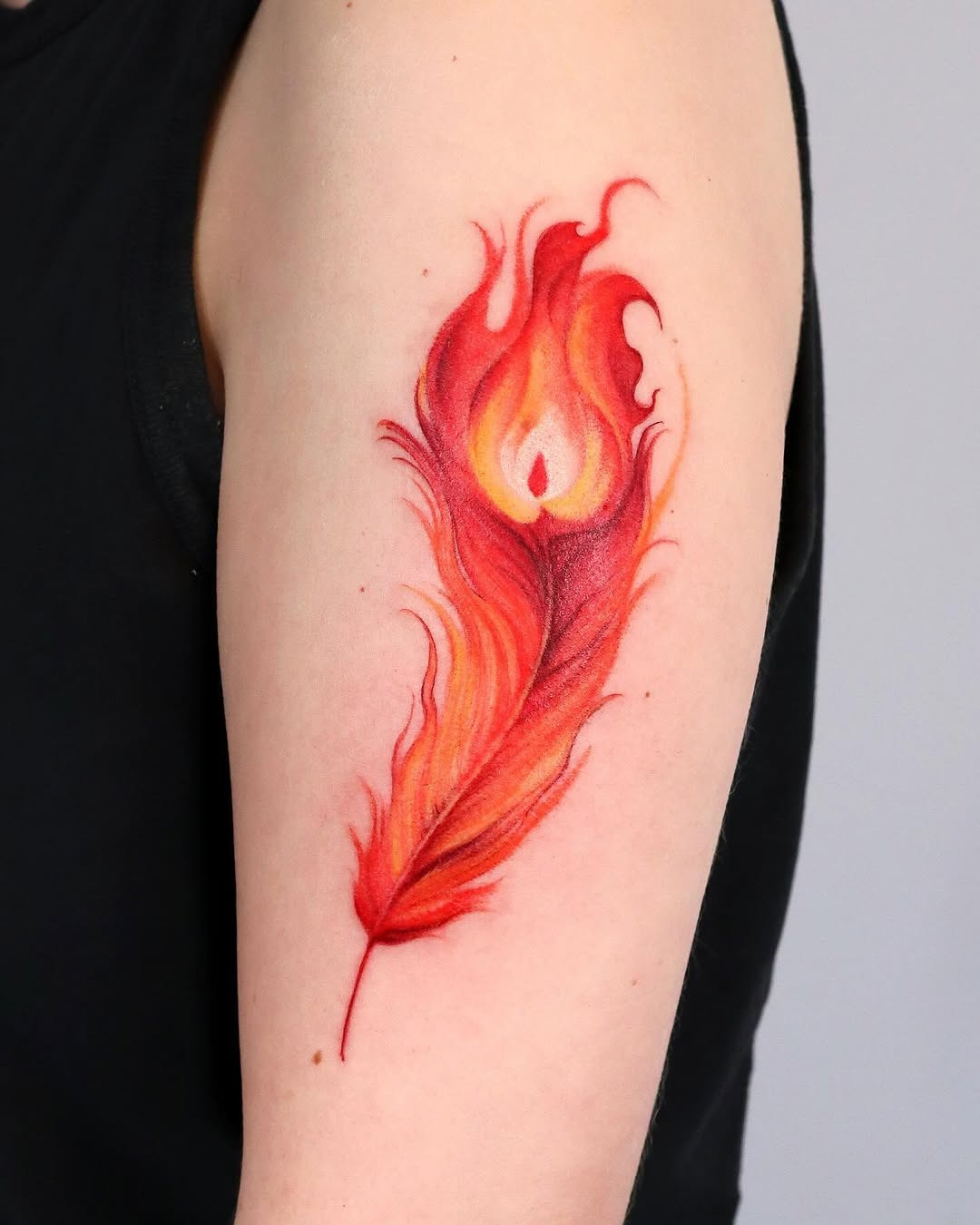 Vibrant feather tattoo with fiery aesthetics Tattoo Design
