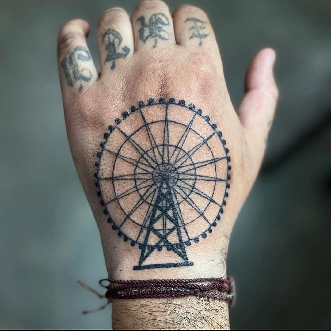 Intricate Ferris wheel tattoo on hand Tattoo Design