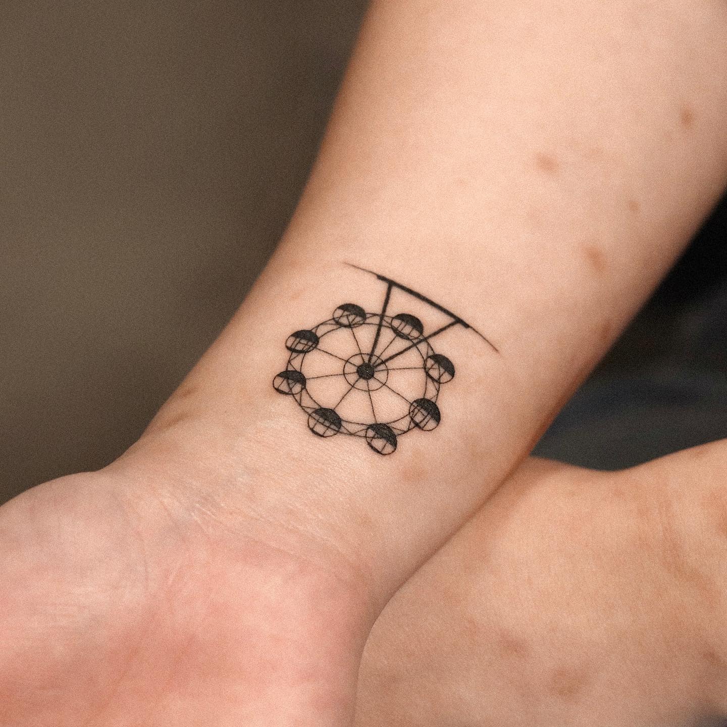 Minimalist Ferris Wheel Tattoo on the Wrist Tattoo Design