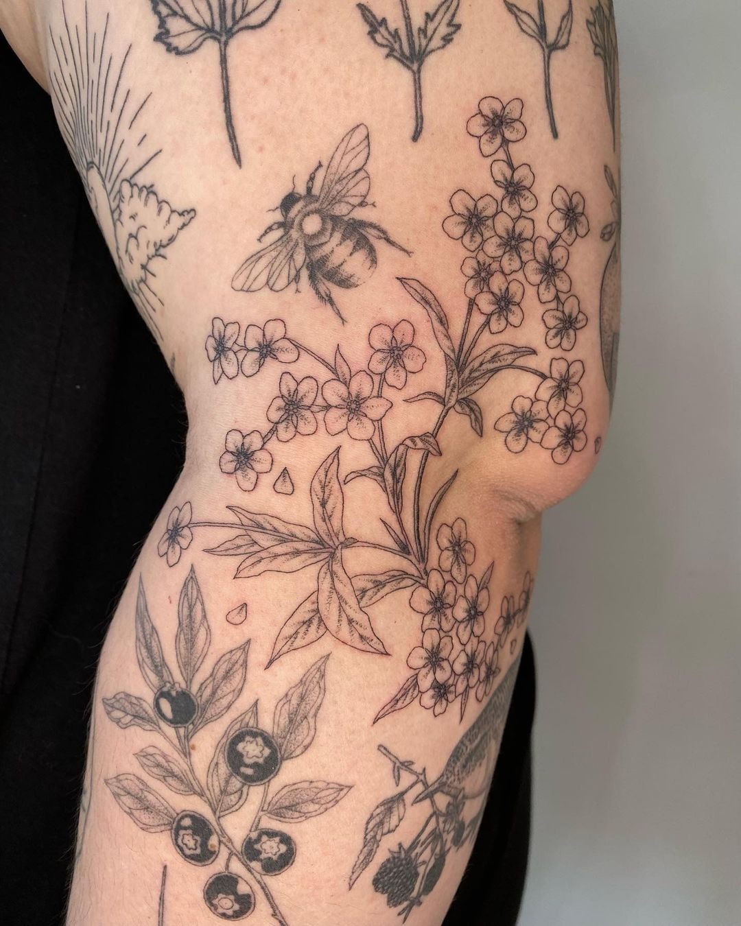 Fine-Line Blossoms, Bees, and Floating Petals, a tattoo design rendered in clean detailed linework for the back.