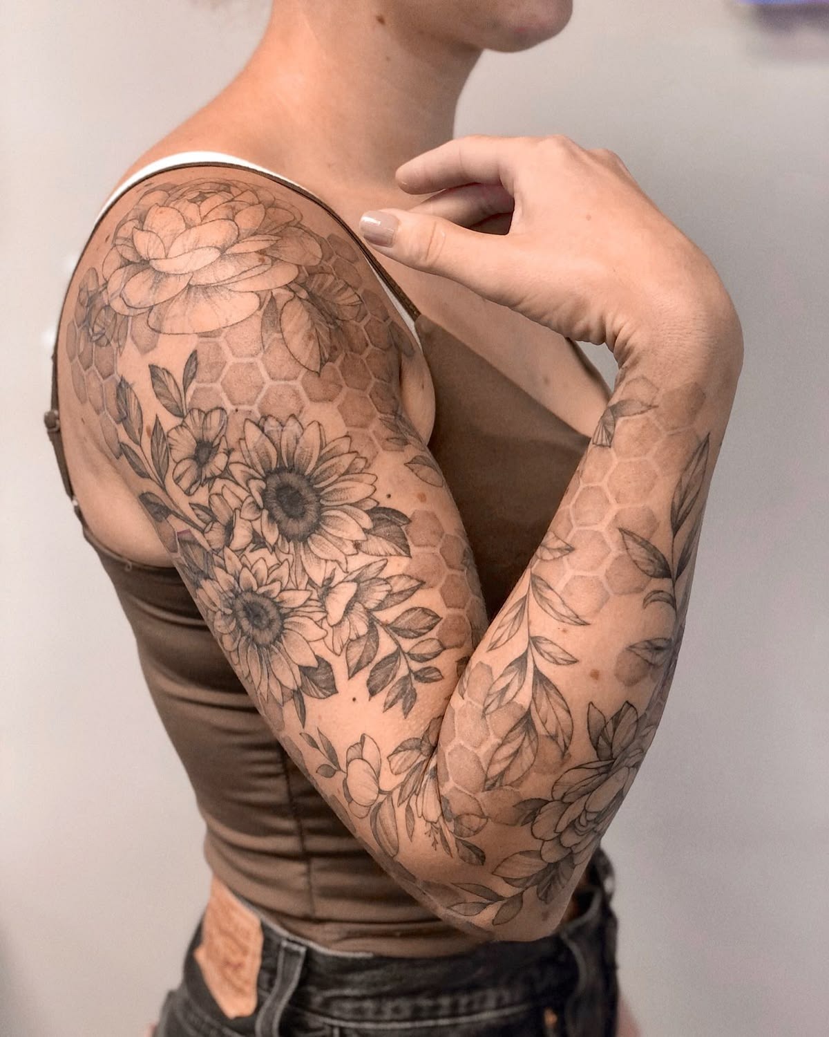 Honeycomb Texture Woven Through a Floral Sleeve, a tattoo design rendered in geometric.