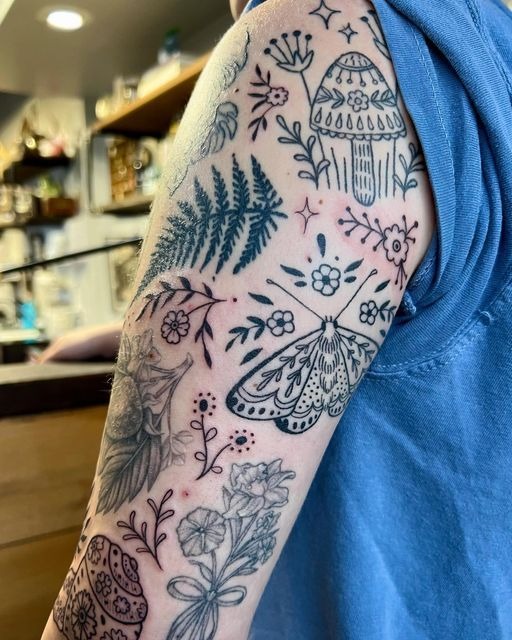 Tiny Nature Doodles for a Charming Patchwork Arm, a tattoo design rendered in clean detailed linework.