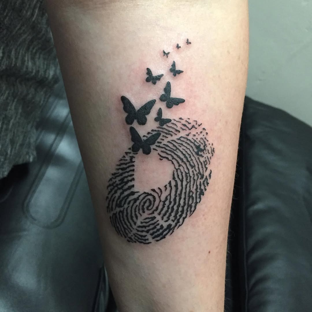Elegant fingerprint tattoo with butterfly details Tattoo Design