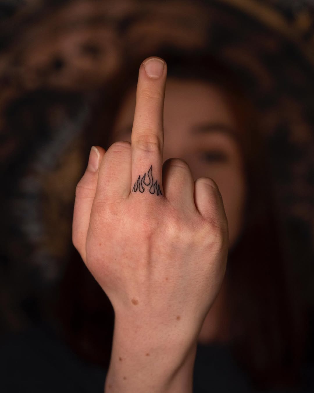 Bold fire tattoo on a raised finger Tattoo Design