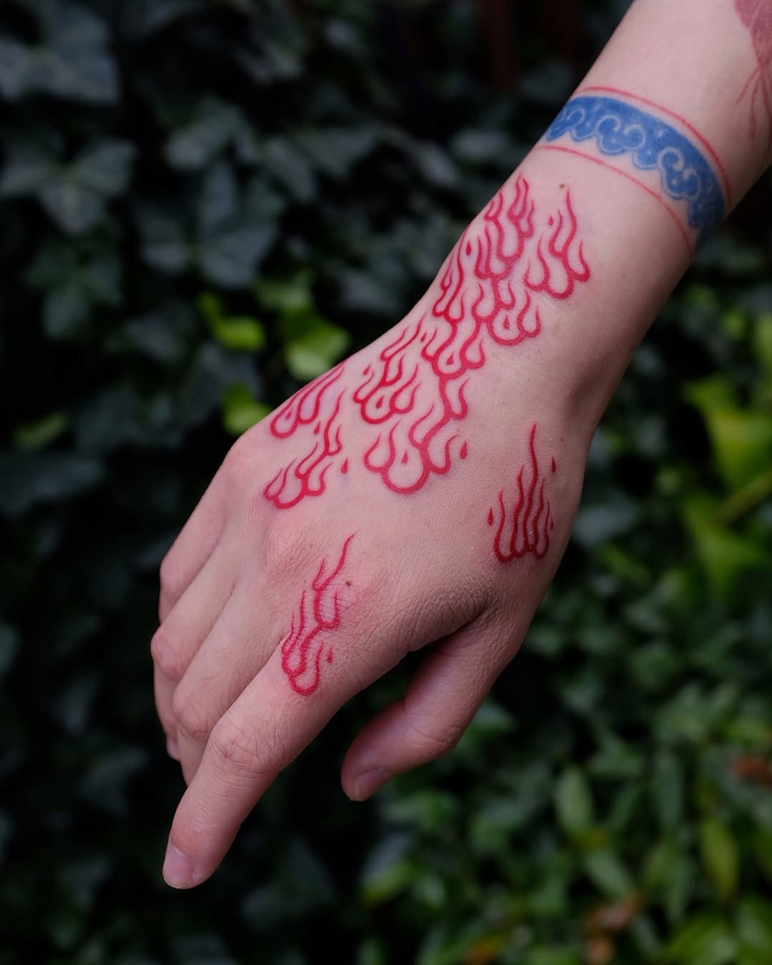 Bold Red Flames Tattoo on Hand Tattoo Design
