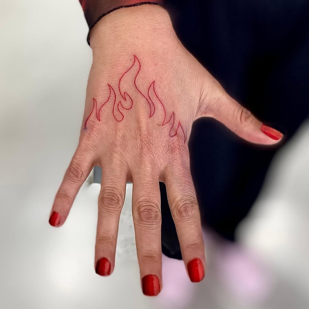 Bold red flames tattooing around the hand Tattoo Design