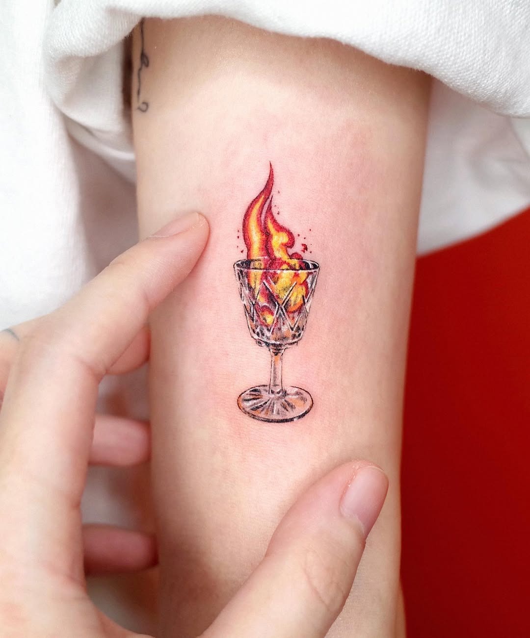 Colorful flame in a glass tattoo design Tattoo Design