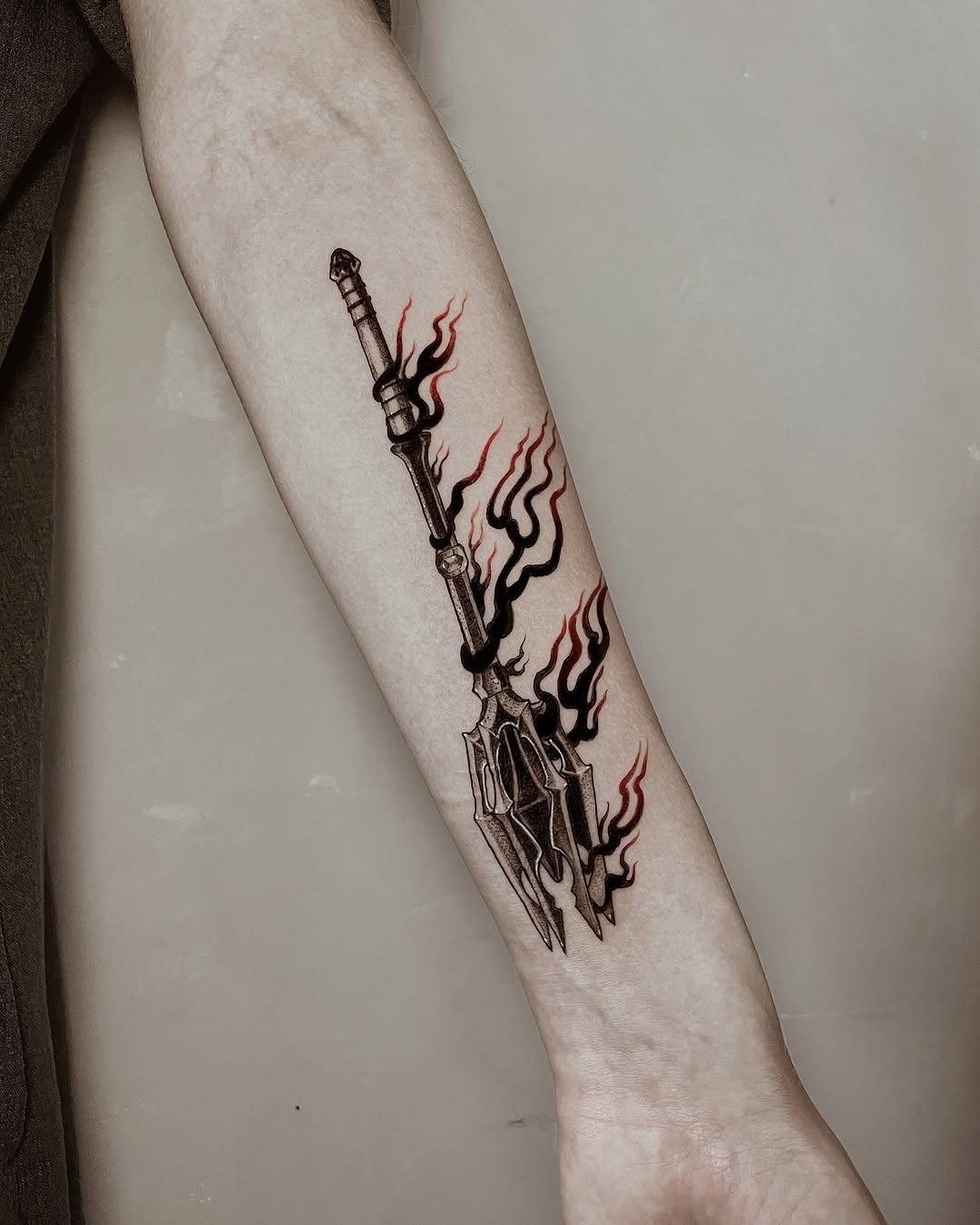 Dramatic spear tattoo with fiery accents Tattoo Design