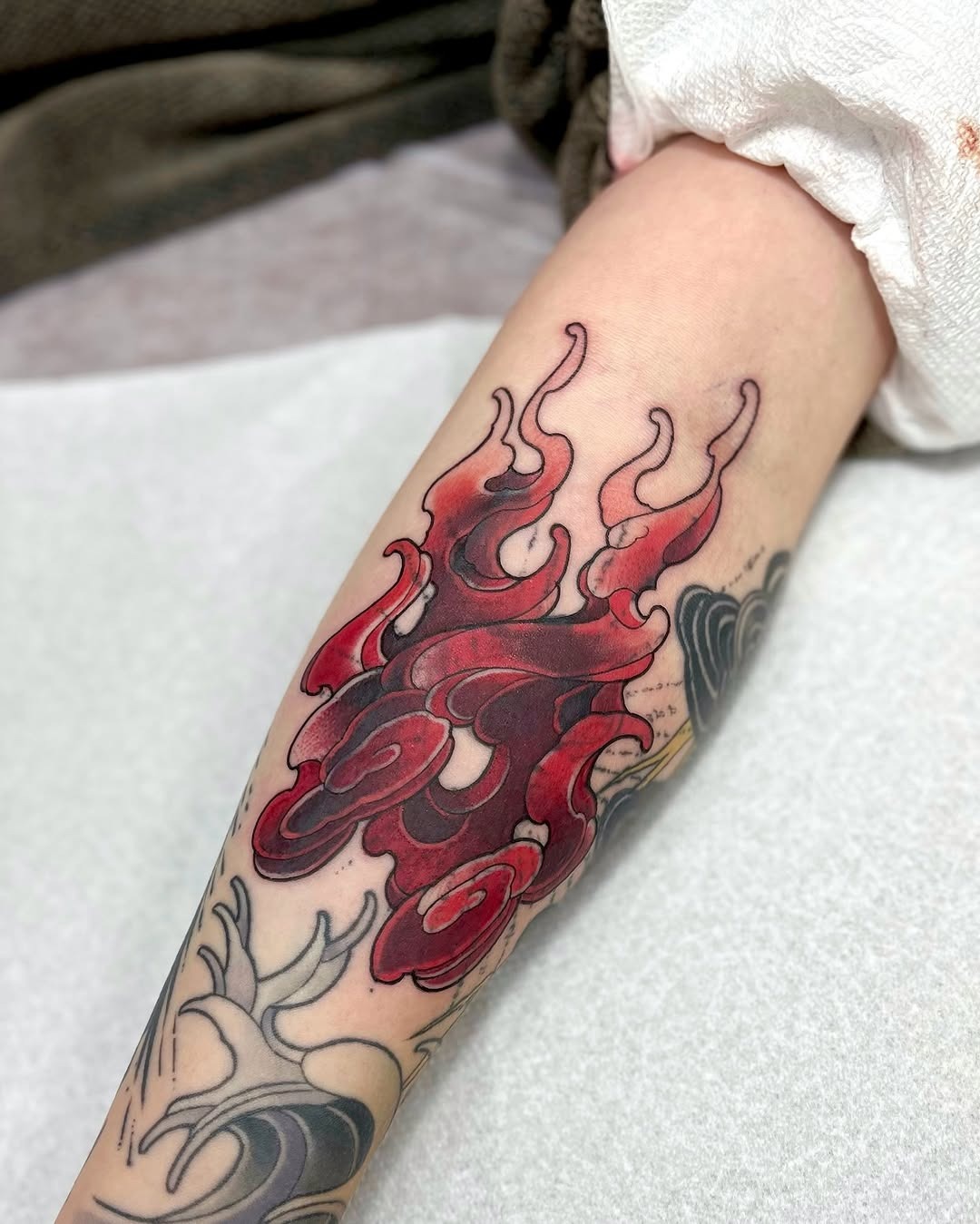 Dynamic red flame tattoo on the forearm Tattoo Design