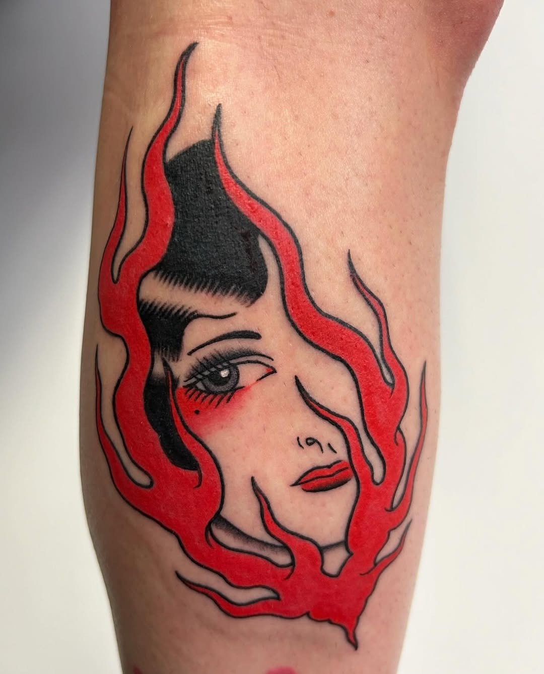 Striking fire tattoo featuring a woman’s face Tattoo Design