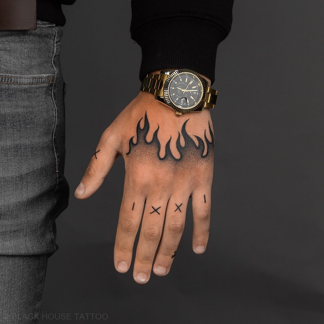 Striking hand tattoo with fiery flame designs Tattoo Design