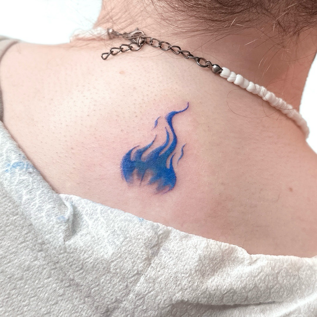 Unique blue flame tattoo on the back Tattoo Design