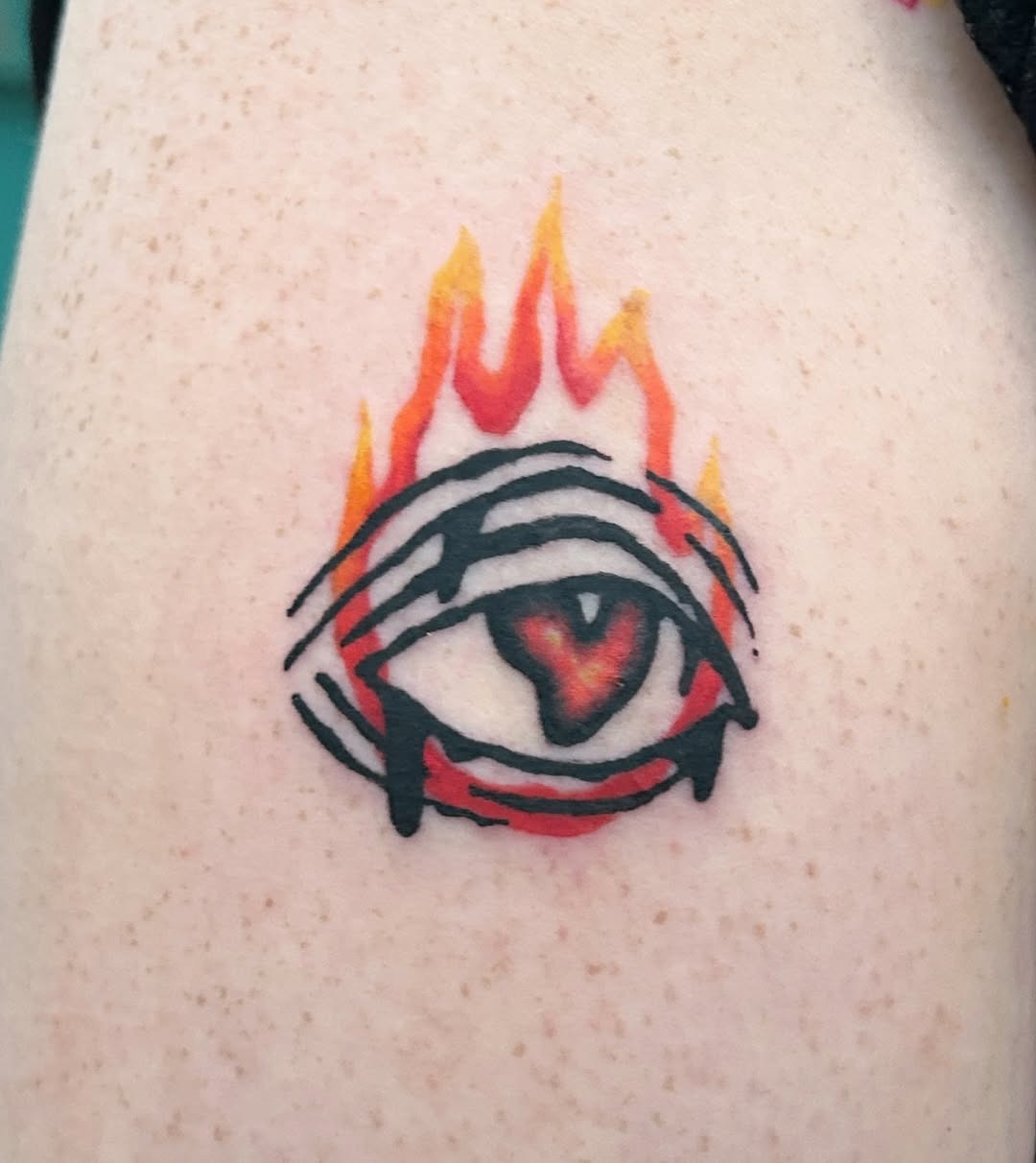 Unique eye tattoo with fiery flames encircling it Tattoo Design