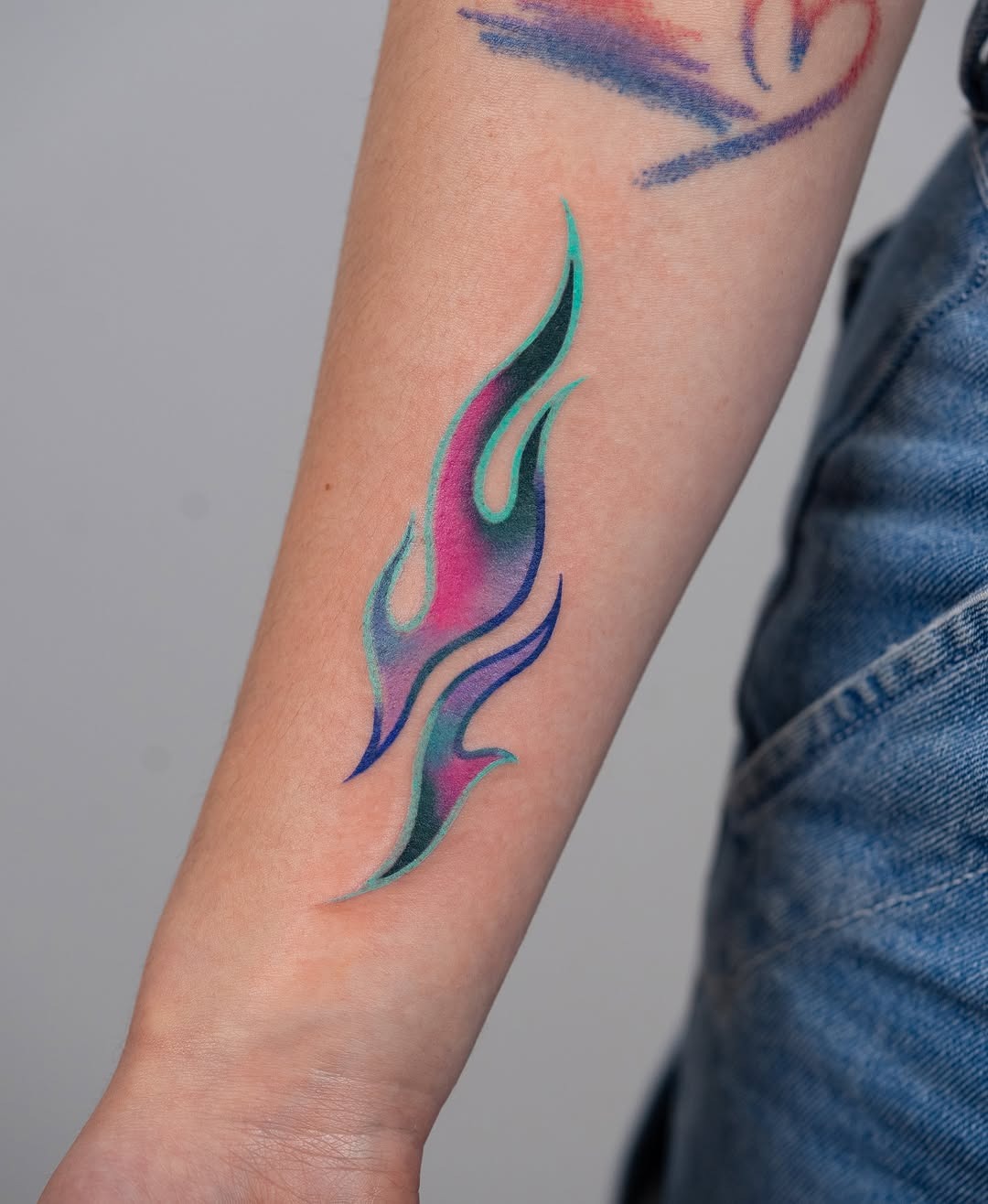 Vibrant Flare with Aqua and Purple Tones Tattoo Design