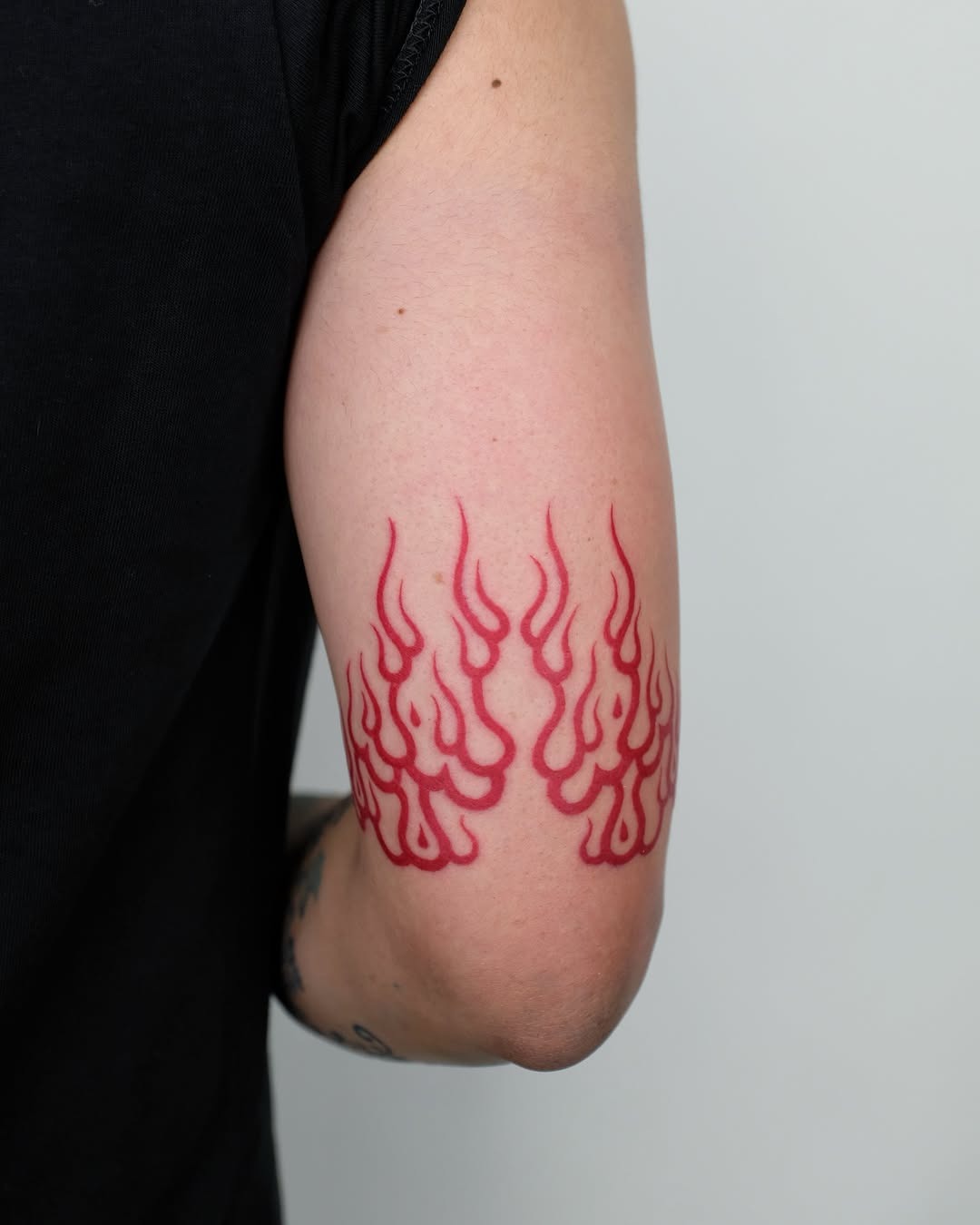 Vibrant Red Flame Tattoo Design on Elbow Tattoo Design