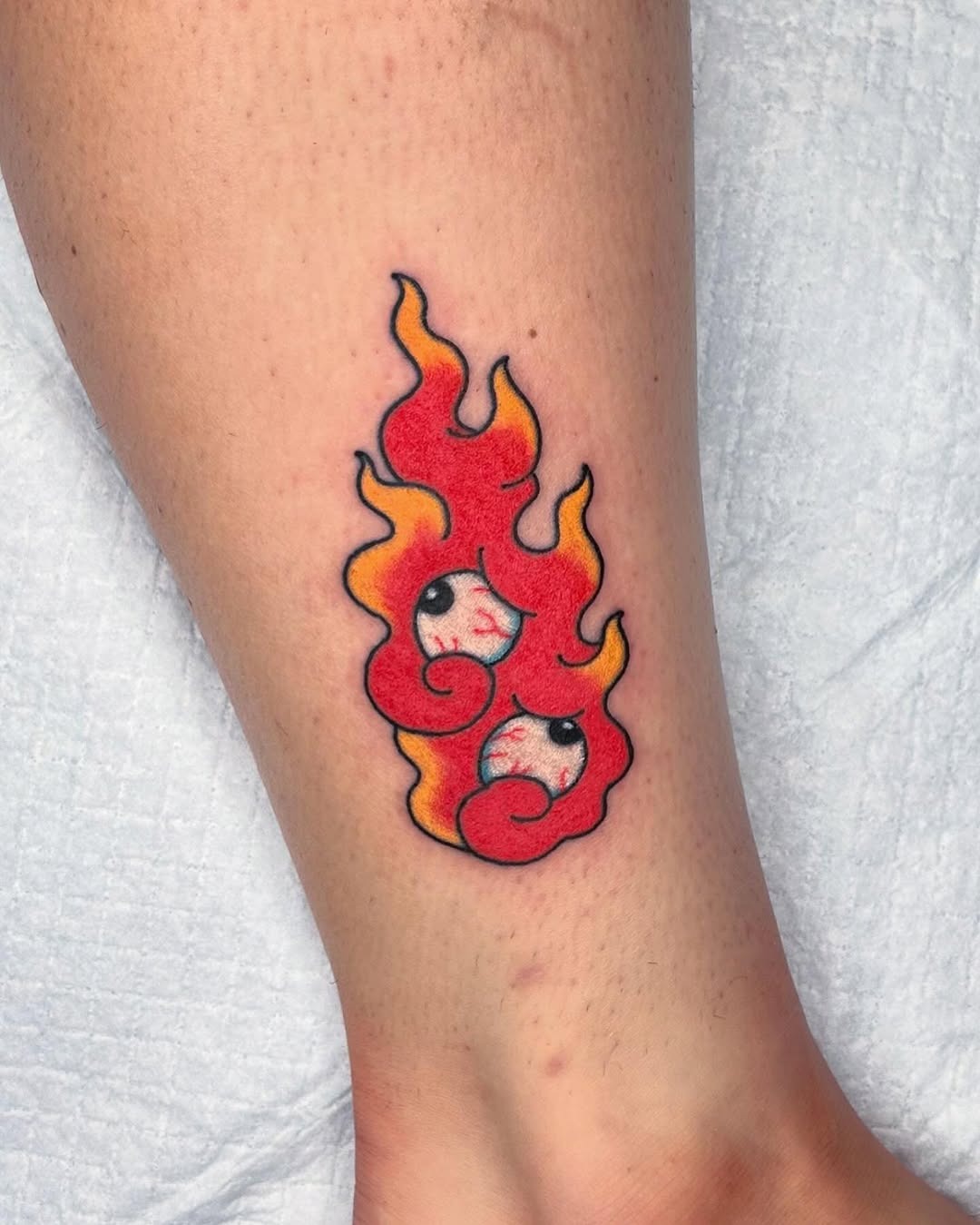 Whimsical Fire Tattoo with Playful Faces Tattoo Design