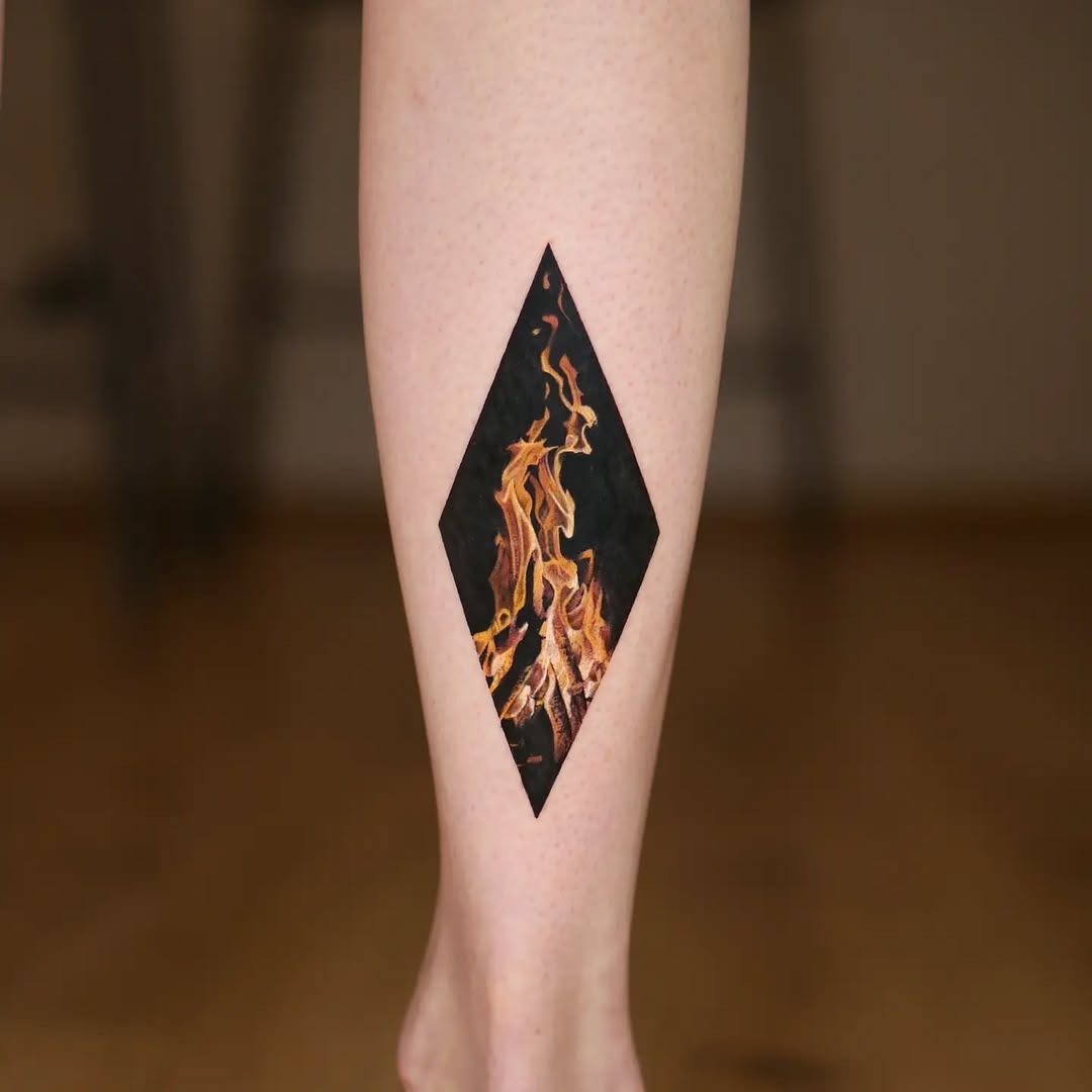 This striking tattoo features flames expertly captured within a diamond shape, reflecting a firefighter's passion for fire and bravery.