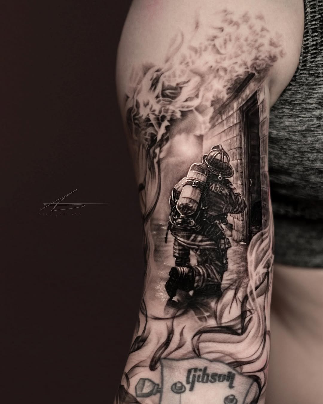 This tattoo showcases a firefighter in action, skillfully captured in a stunning black and gray design.