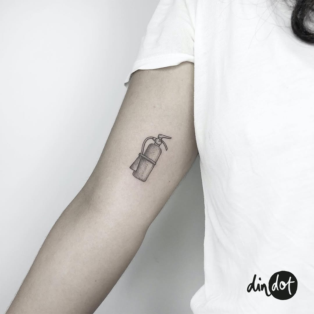 This tattoo features a detailed ink illustration of a fire extinguisher, embodying the spirit of firefighting.