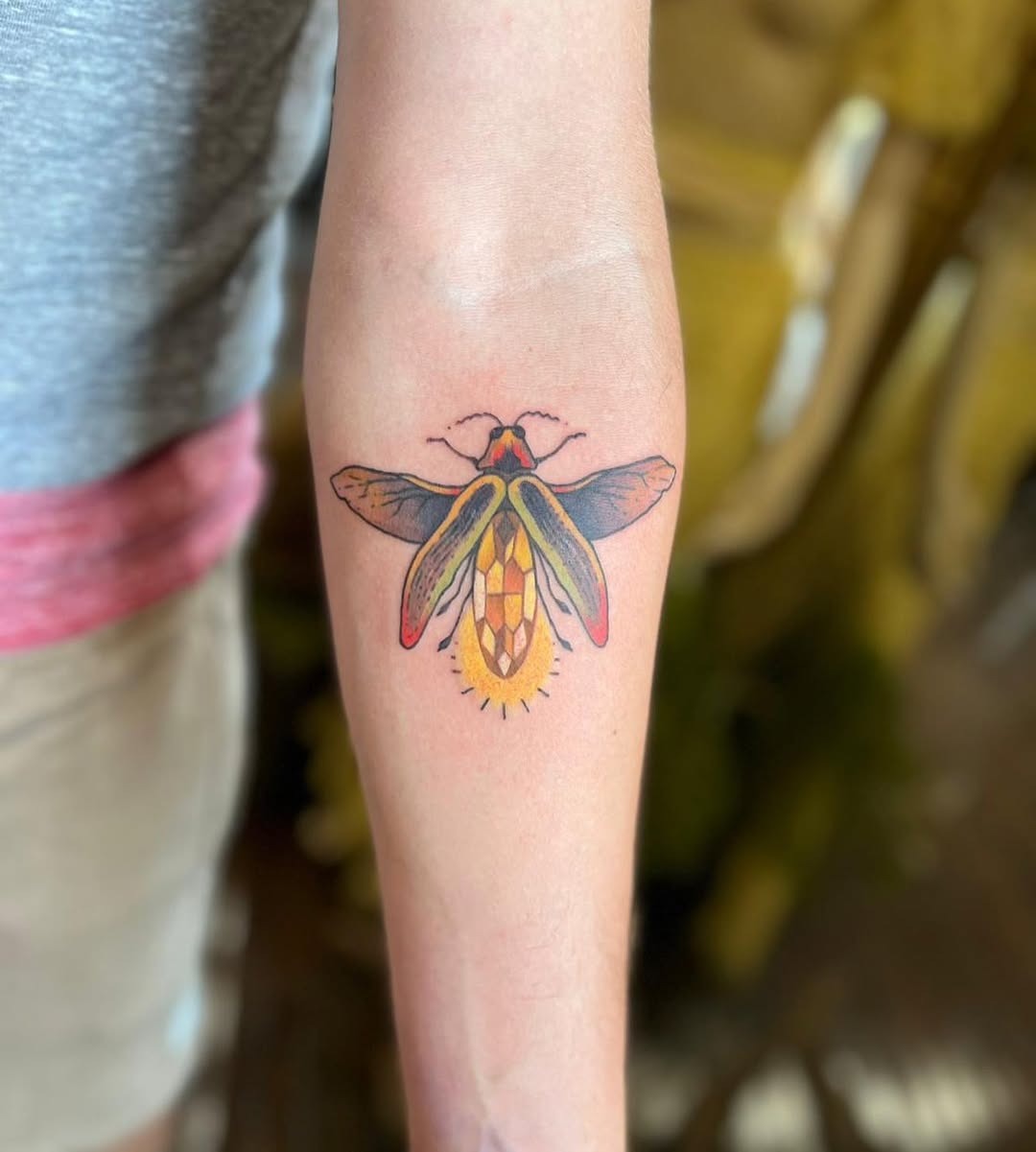 This firefly tattoo showcases intricate detailing and colors that pop.