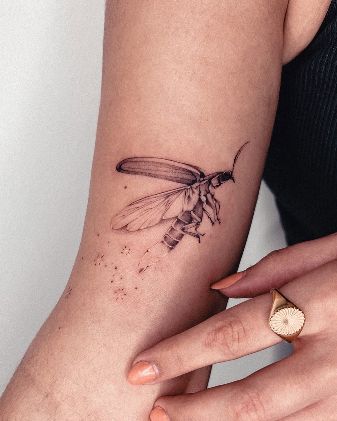 This stunning firefly tattoo showcases delicate detailing, bringing the insect to life on the skin.