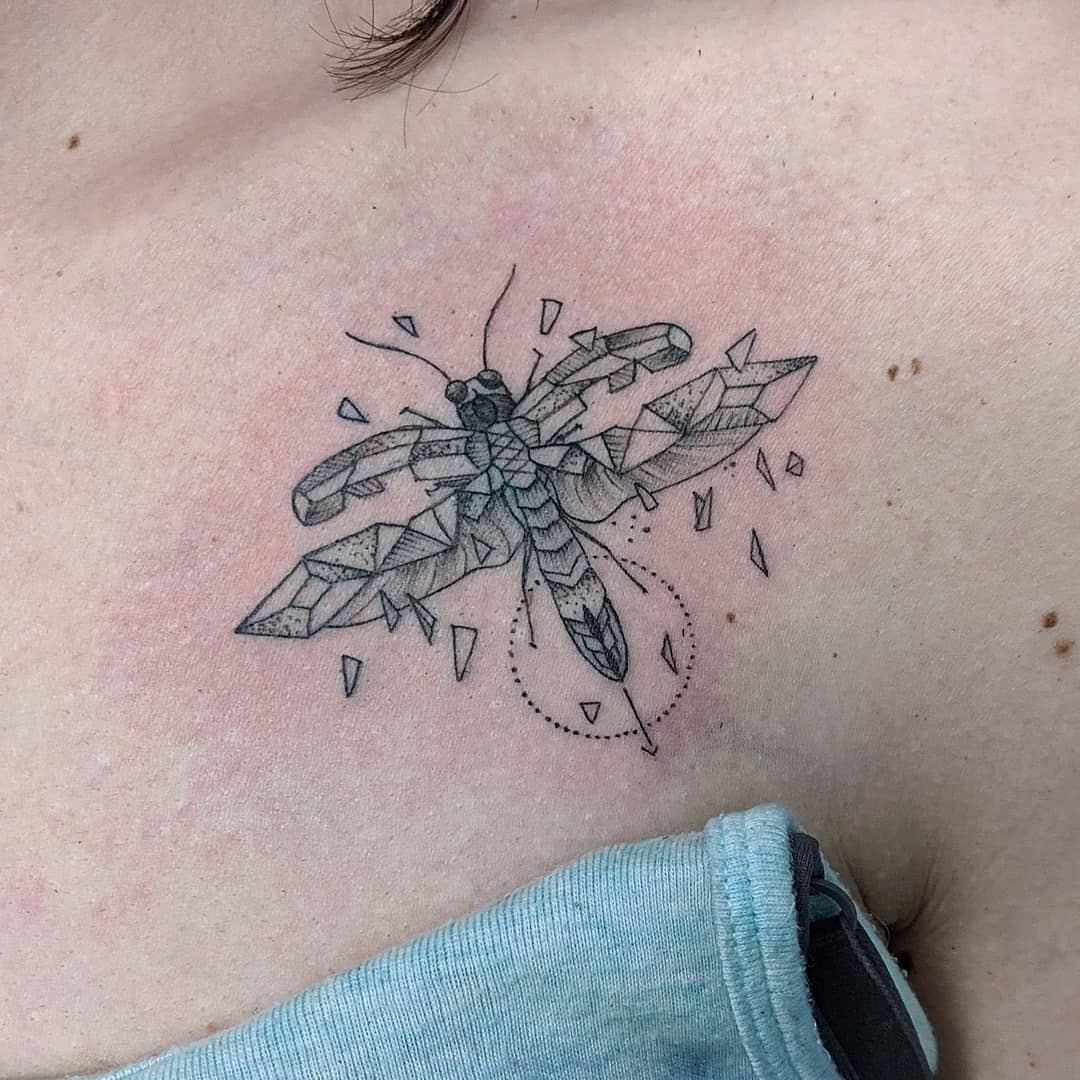 This tattoo showcases a beautifully intricate geometric firefly design.