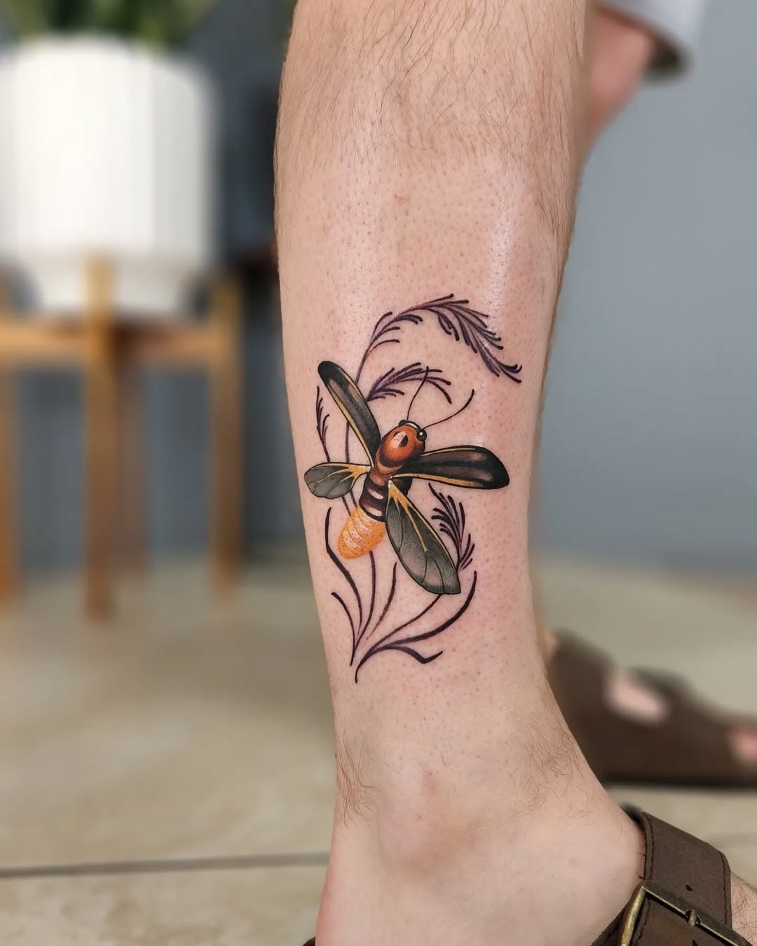 This firefly tattoo showcases a beautiful blend of colors.