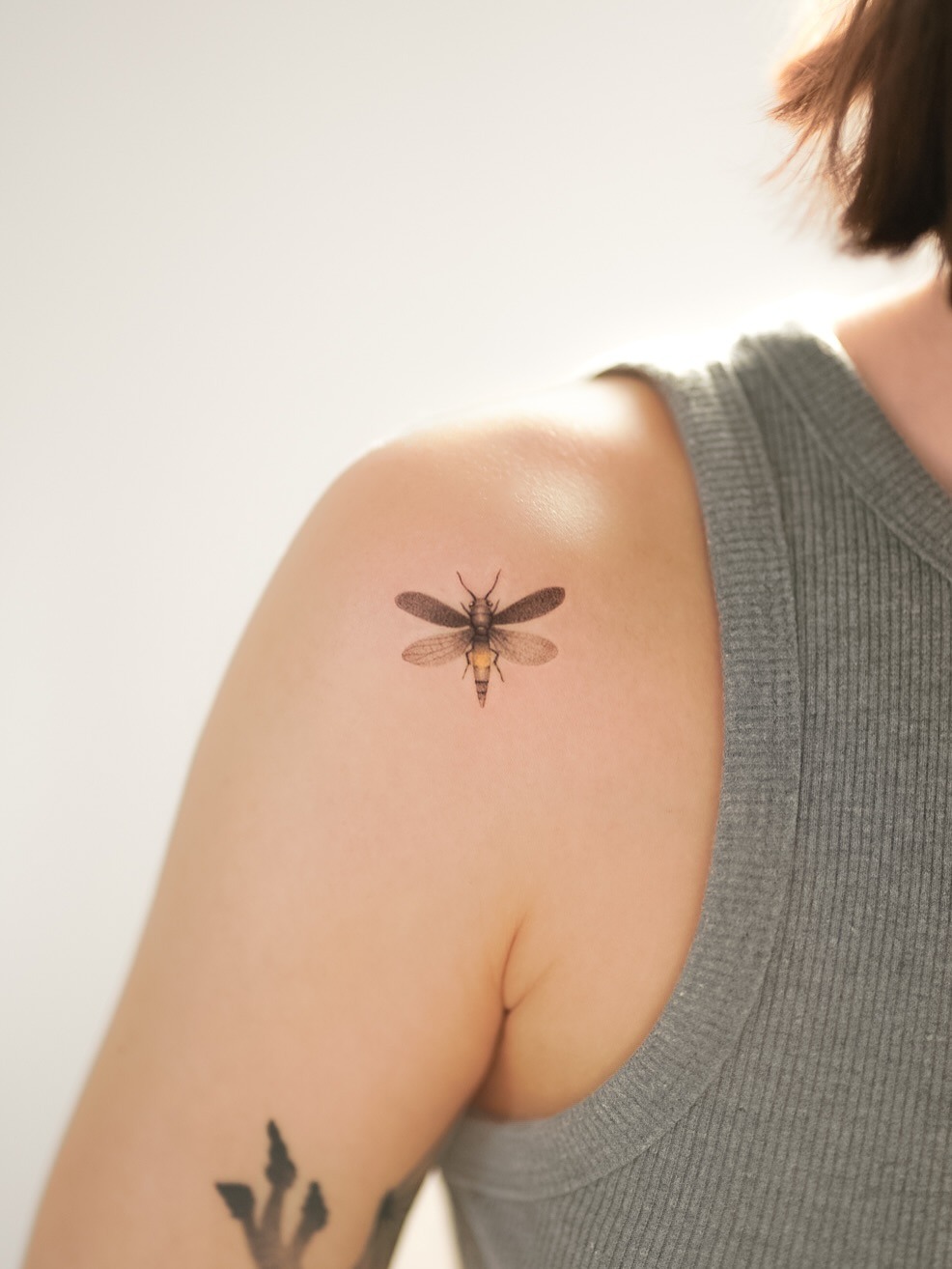 This firefly tattoo showcases intricate detailing, embodying a sense of nature's beauty.