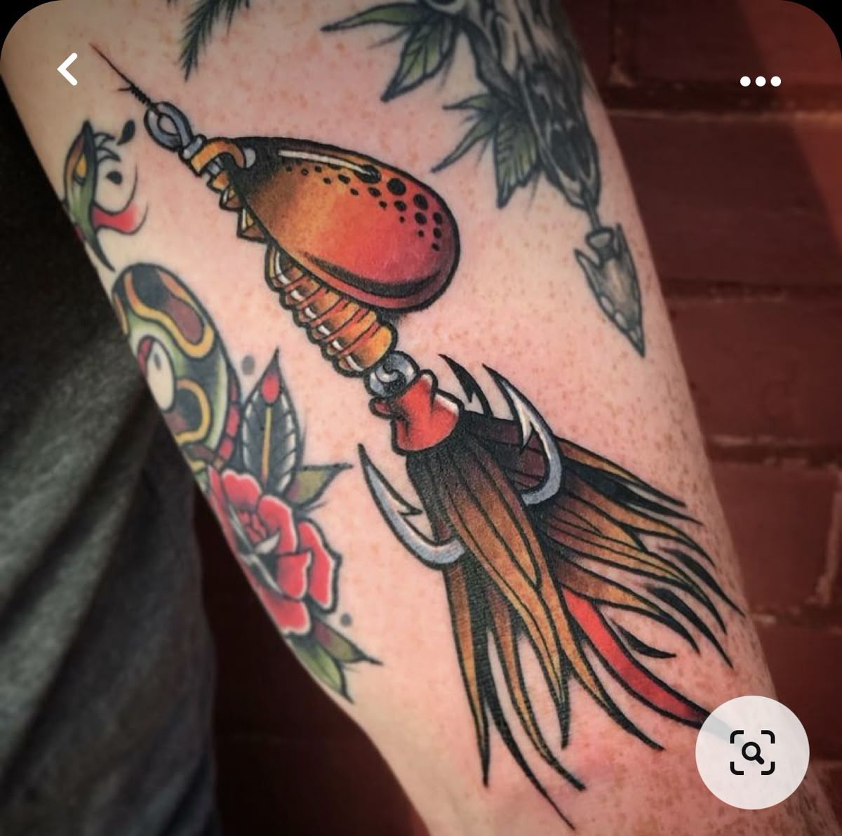 American Traditional Fishing Spinner Tattoo, a tattoo design rendered in bold traditional for the arm.