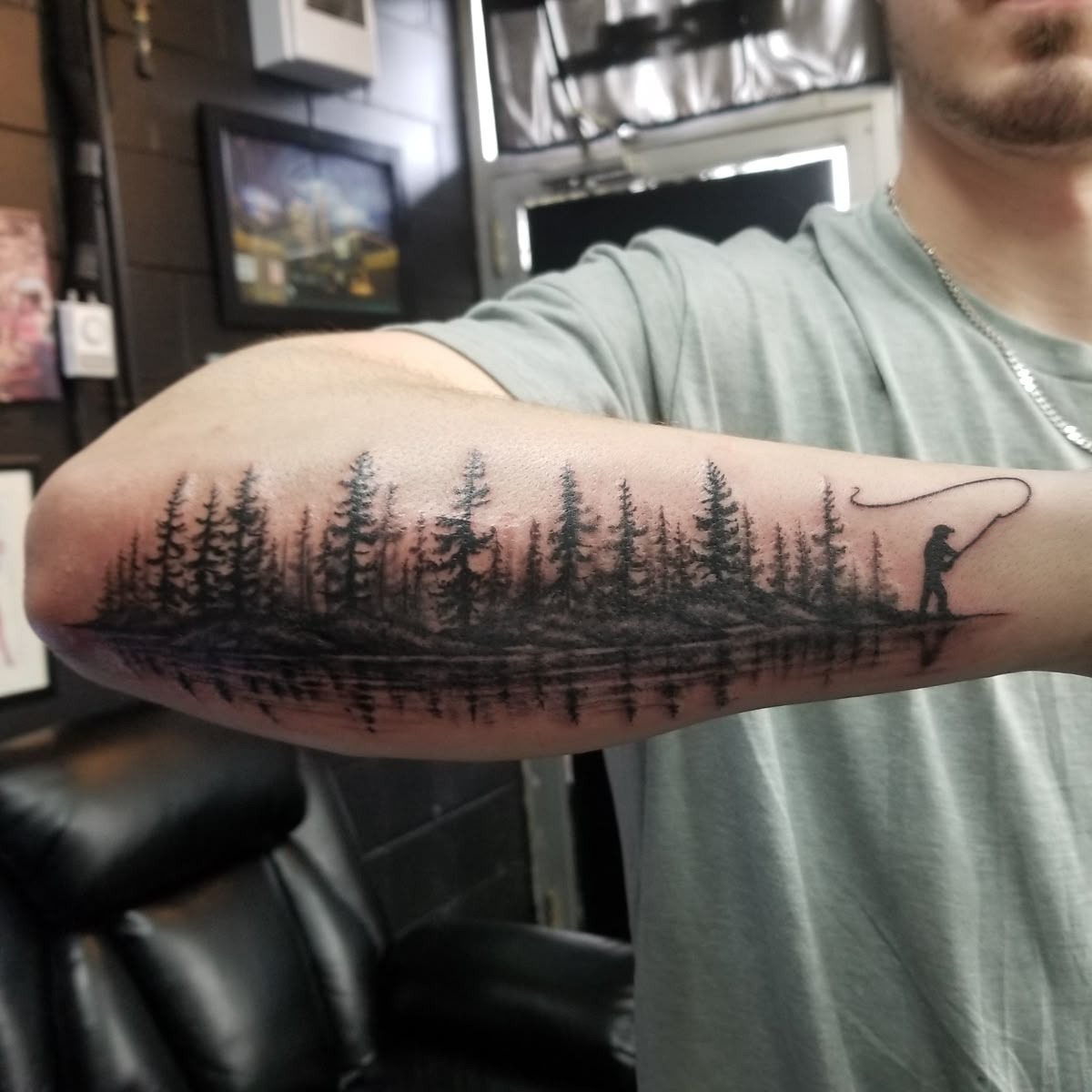 Forest Silhouette Fishing Sleeve, a tattoo design rendered in clean detailed linework.