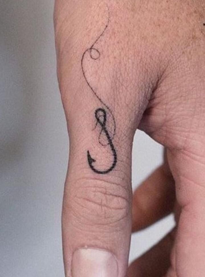 Minimal Fine Line Hook Finger Tattoo, a tattoo design rendered in delicate fine-line for the leg.