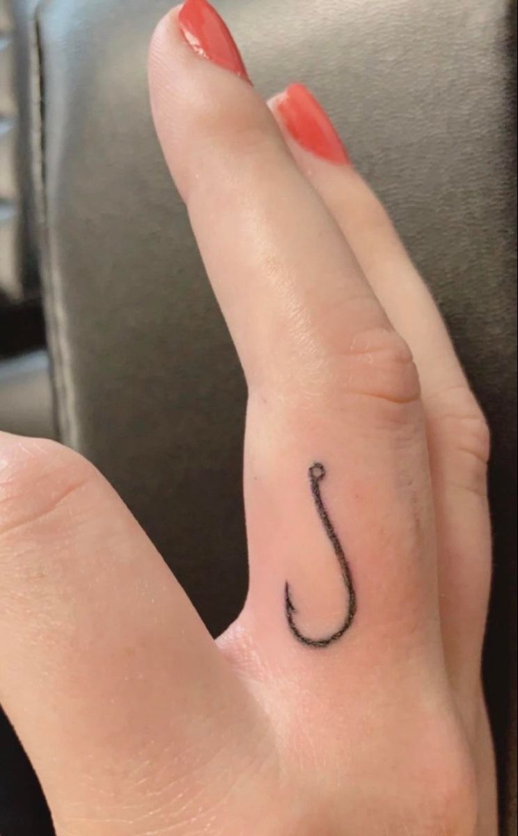 Minimal Simple Fishing Hook Finger Tattoo, a tattoo design rendered in delicate fine-line for the arm.