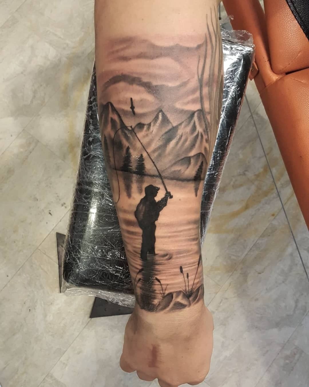 Realistic Scenic Fishing Landscape Tattoo, a tattoo design rendered in realistic portrait-style.