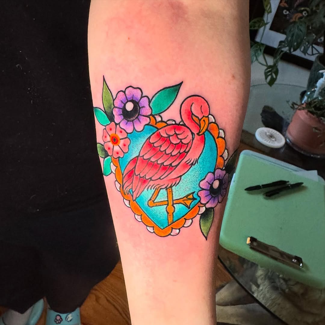 Colorful flamingo surrounded by floral designs Tattoo Design