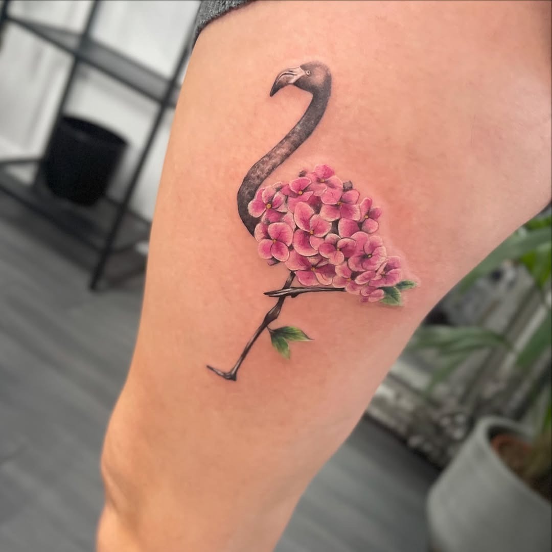 Stylish flamingo tattoo with vibrant florals Tattoo Design