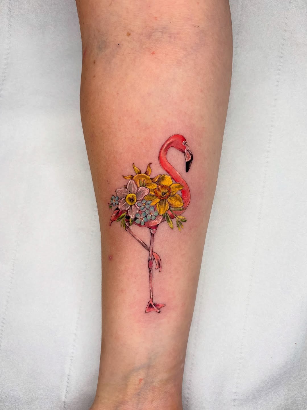 Whimsical flamingo tattoo adorned with flowers Tattoo Design