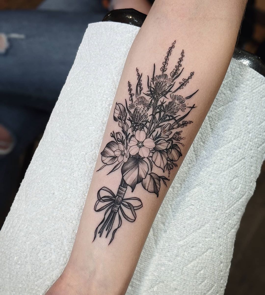 Fineline Bouquet With a Bow for Quiet Romance, a tattoo design rendered in delicate fine-line for the rib.