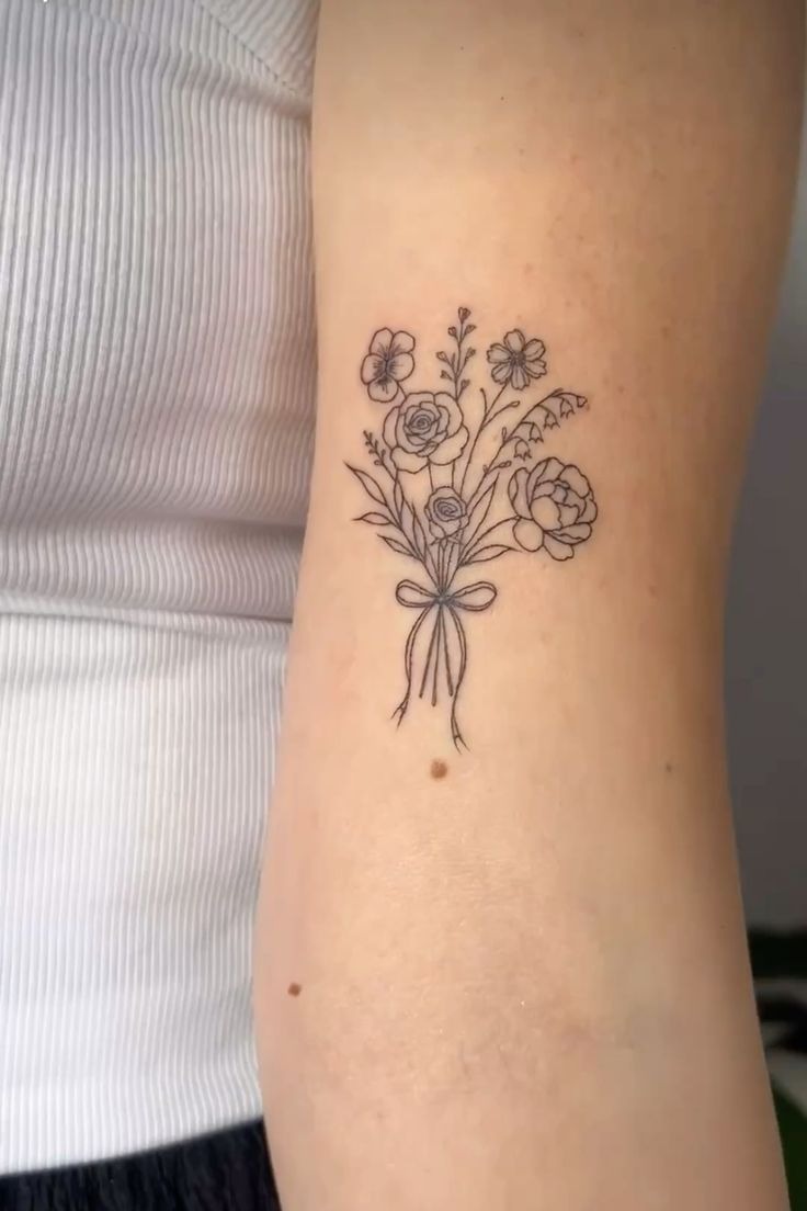 Simple Fine-Line Bouquet With a Tiny Bow, a tattoo design rendered in clean detailed linework for the arm.