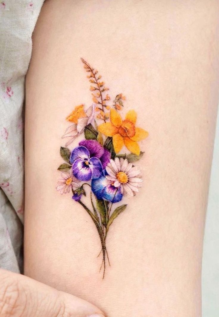 Tiny Color Bouquet for a Sweet, Wearable Statement, a tattoo design rendered in clean detailed linework for the arm.