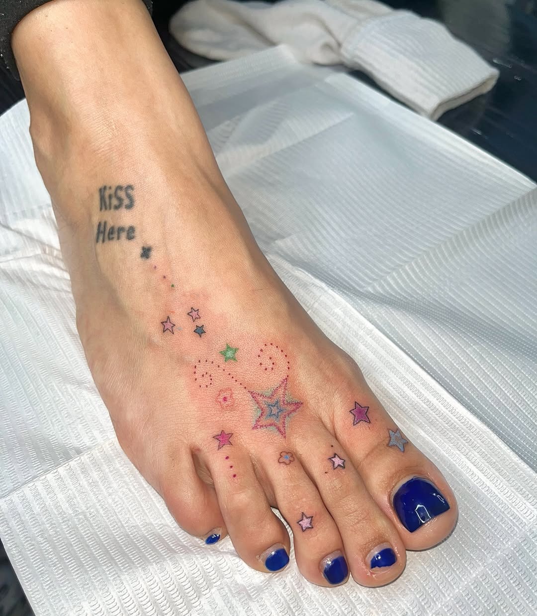 Charming foot tattoo with playful star design Tattoo Design