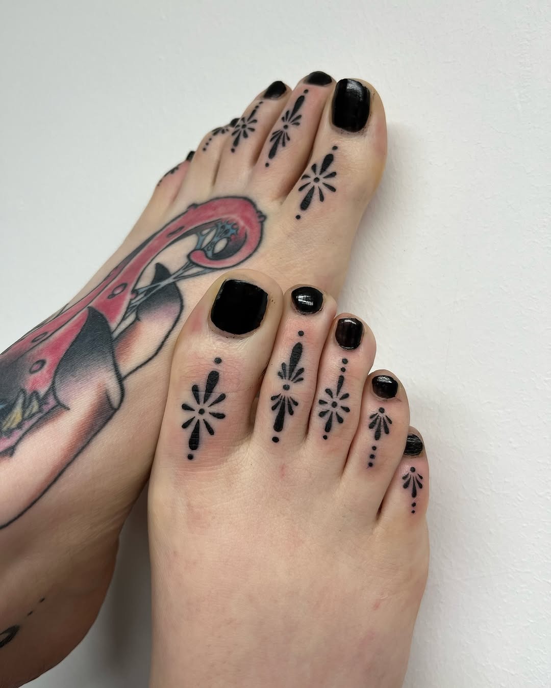 Elegant foot tattoos with floral details Tattoo Design