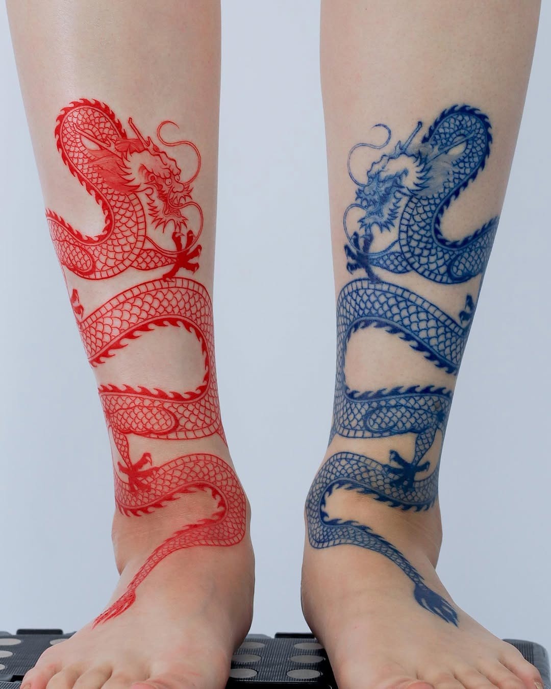Striking Dragons in Bold Colors on Feet Tattoo Design