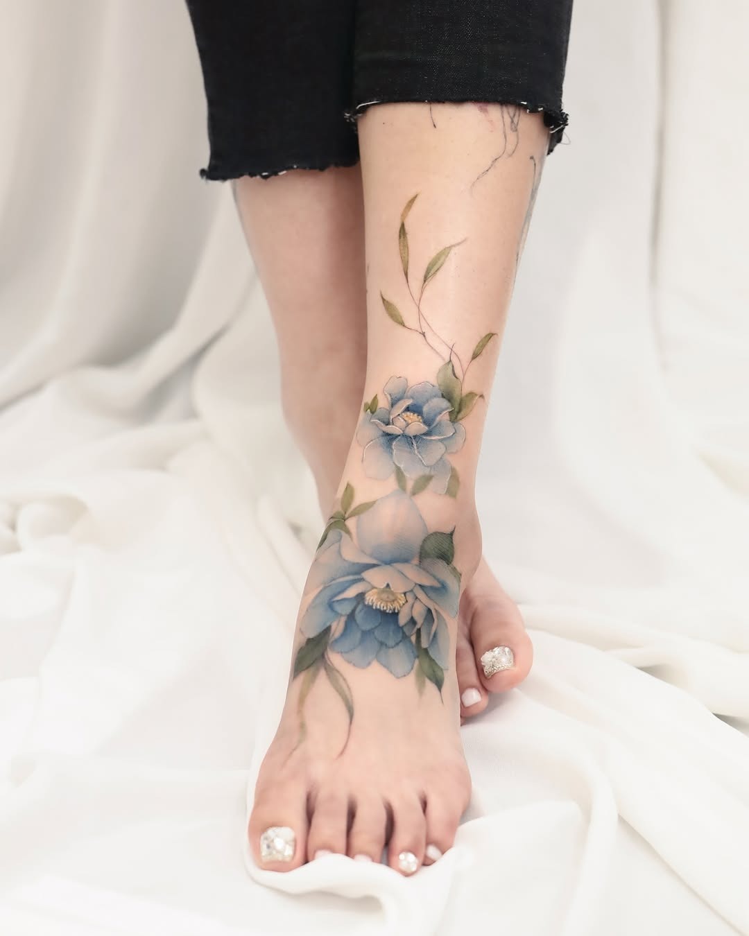 Stunning floral foot tattoo with elegant colors Tattoo Design