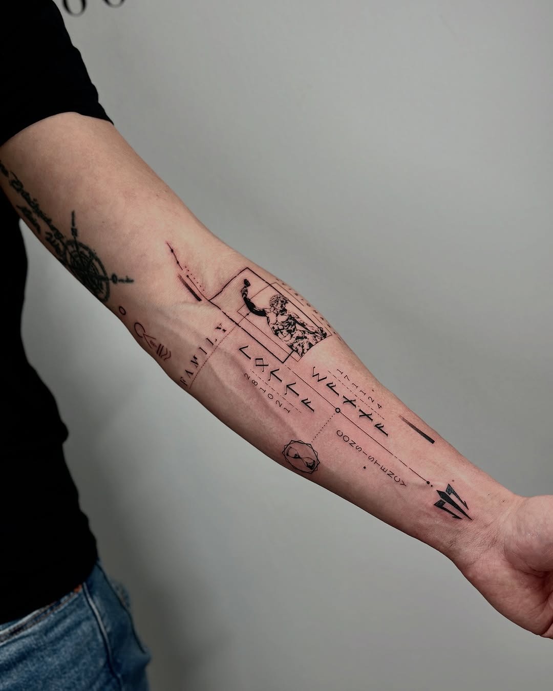 This tattoo features a blend of geometric shapes and abstract lines, creating a unique minimalist look.