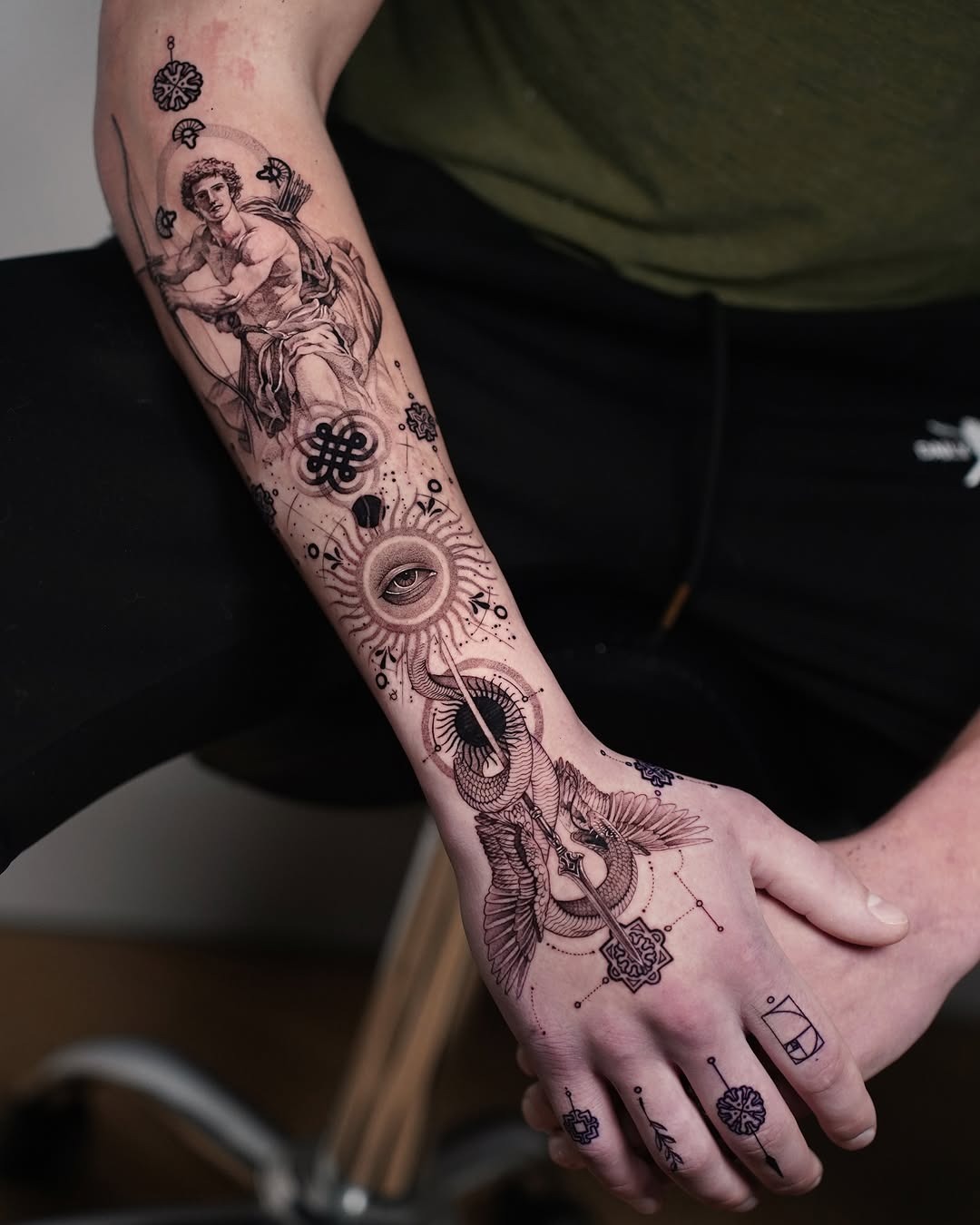 This forearm tattoo showcases a blend of classical and contemporary artistry.