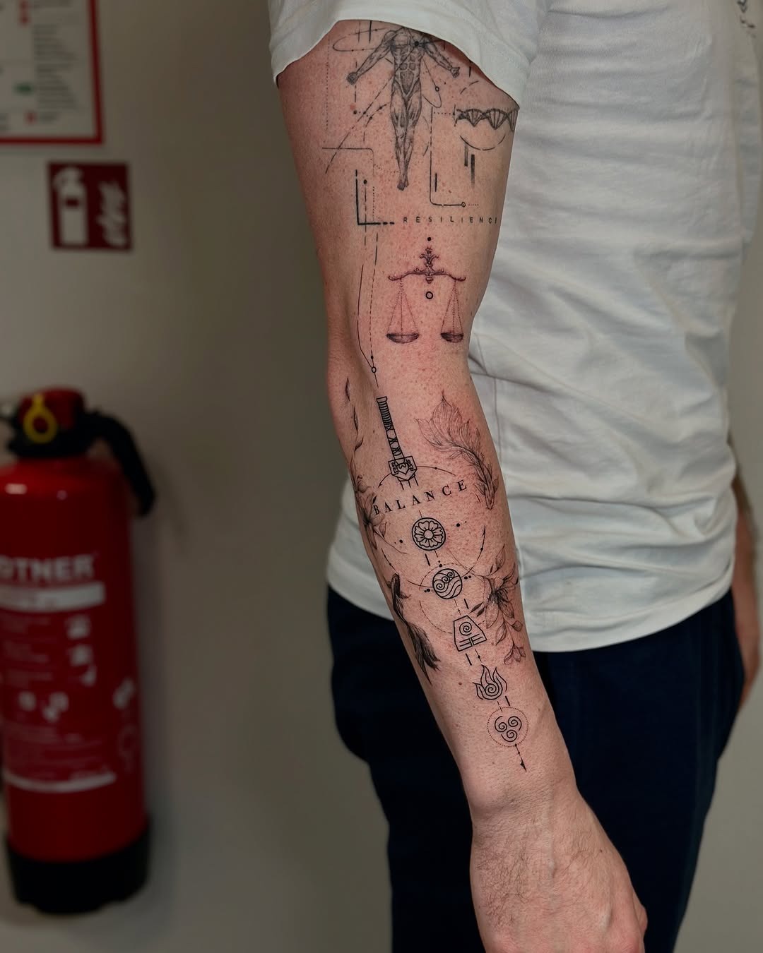 This forearm tattoo showcases a unique blend of symbols, emphasizing balance and harmony.