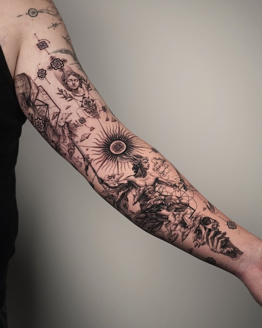 This stunning forearm tattoo showcases a dynamic blend of intricate designs and bold imagery.
