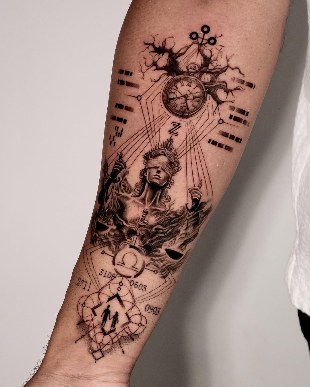 This forearm tattoo showcases an impressive blend of intricate designs, featuring a mythical figure surrounded by clock elements and abstract symbols.
