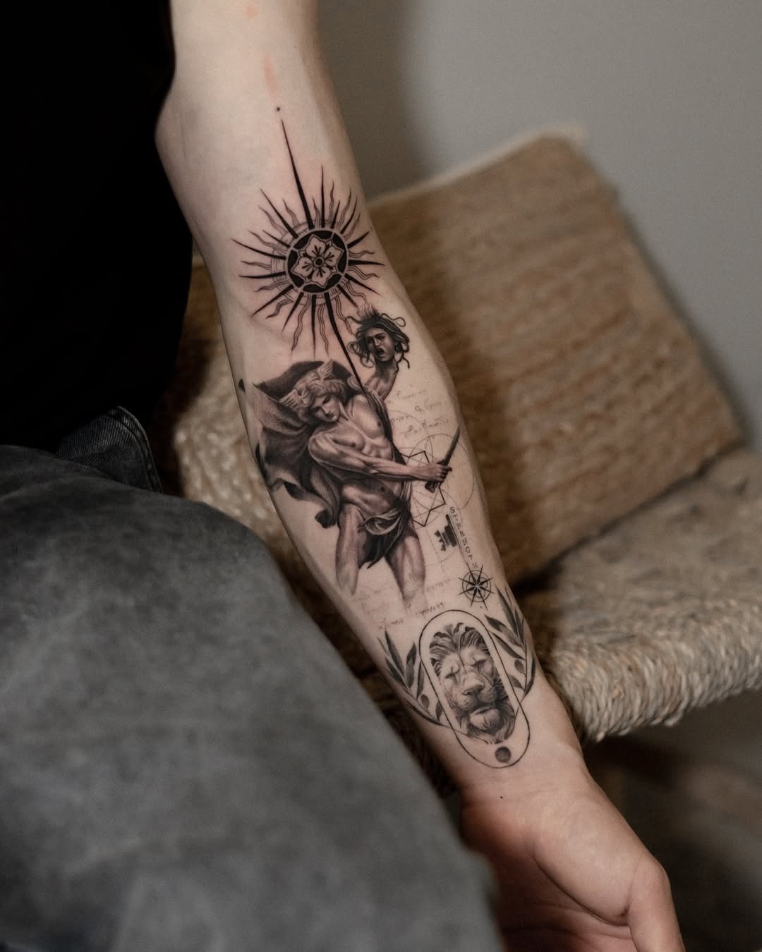 This forearm tattoo showcases a beautifully detailed representation of mythological figures intertwined with celestial elements.
