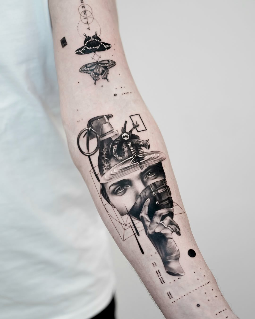 This forearm tattoo is a stunning blend of surrealism and fine line work.